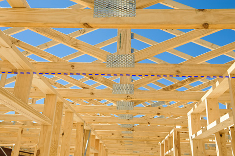 Image truss roof rafters as viewed from th ground.